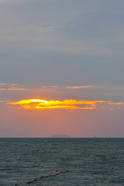 Sunset light shines through the clouds with island background