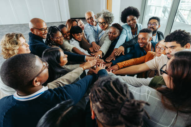 istock Teamwork and unity in business with multiethnic colleagues joining hands together 2204839064