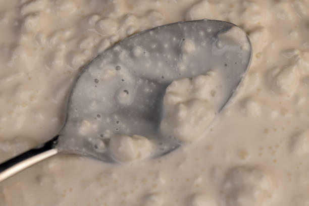 istock cottage cheese made from lumps with cream close-up 2204839110