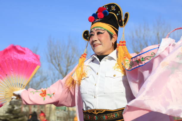 Man in traditional Chinese opera costume looking away