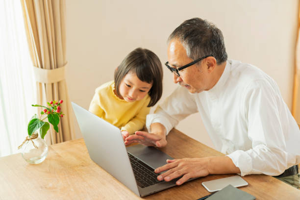 istock Grandfather and grandson working remotely 2204841592