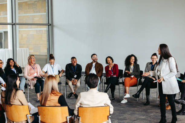 istock Motivational speaker engaging with an audience in a lively conference setting 2204842545