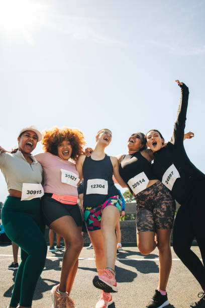 istock Group of happy friends participating in a fun run event 2204843140