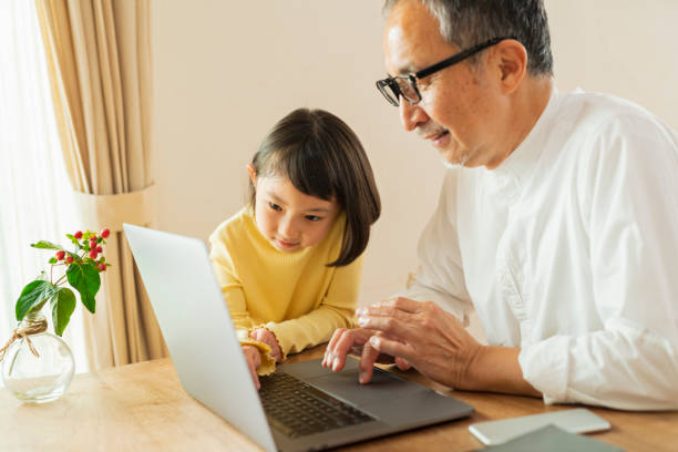istock Grandfather and grandson working remotely 2204843164