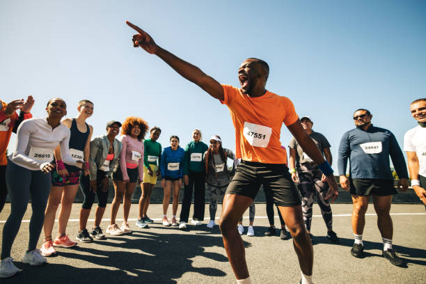 istock Energetic running coach hyping up diverse group before a race 2204843210