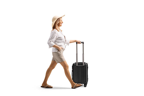istock Full length profile shot of a female tourist pulling a suitcase 2204845849
