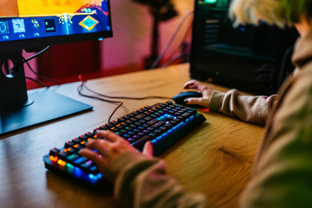 istock Young Woman Playing A Video Game On Her Desktop PC 2204848681
