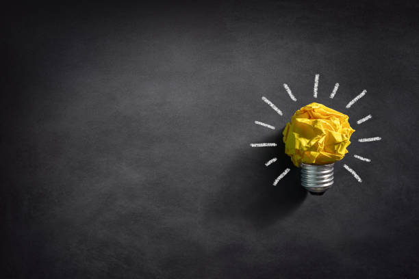 istock Good idea background crumpled yellow paper light bulb 2204848916