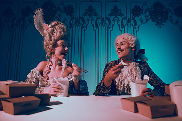istock Elegant couple in historical attire dining in a modern setting with neon lighting 2204849019