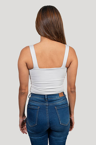 istock Young model showing back of white tank top and jeans 2204849765