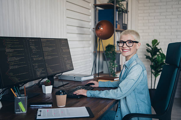 istock Young professional woman coding on a computer in a stylish home office 2204849942