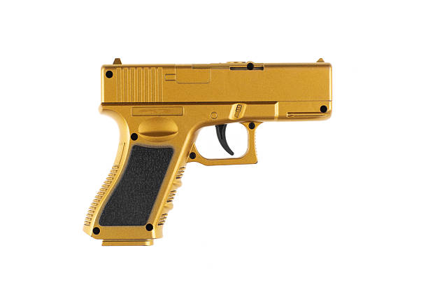 istock toy golden pistol isolated on white background 2204850004