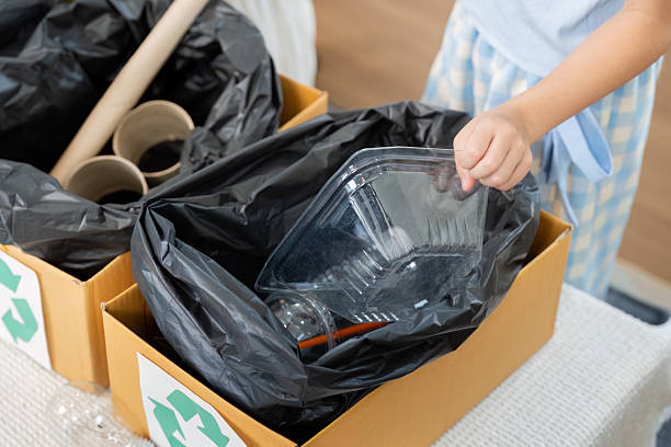 istock Waste Management and Recycling Awareness. Organizing recyclables in a child's activity. 2204850937