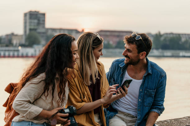 istock Friends sitting on a river side 2204850999