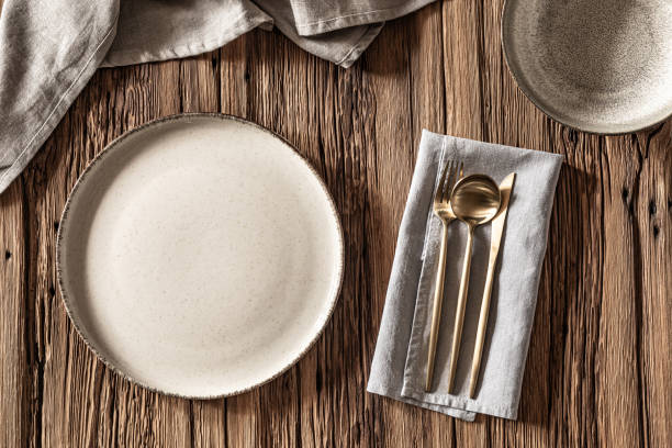 istock Elegant dining setup with rustic wooden table and chic tableware arranged for mealtime enjoyment 2204851198