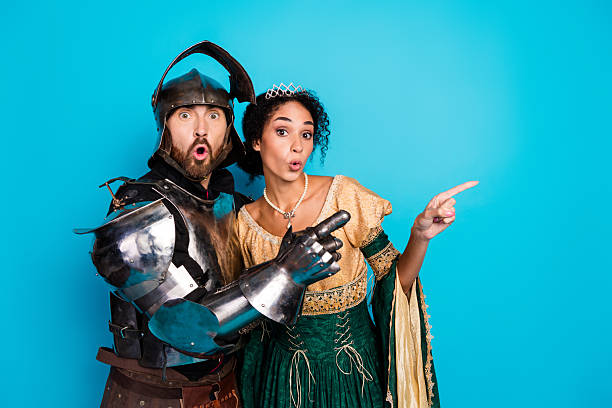 istock Joyful couple in medieval attire gesturing playfully against a vibrant background. 2204851332