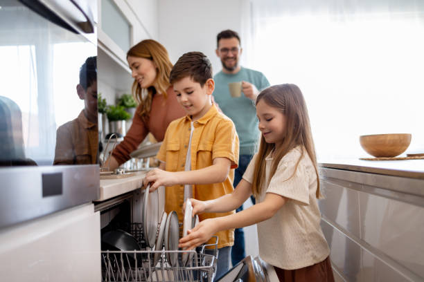 istock Happy family loading the dishwasher 2204851629
