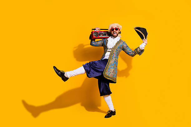 istock Historical character dancing joyfully with a modern boombox on yellow background 2204851640
