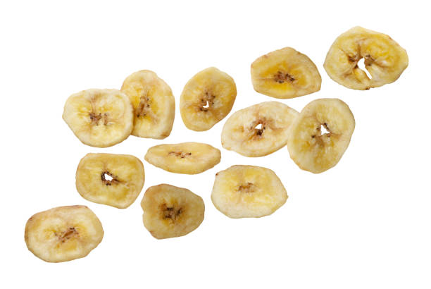 istock Dried banana chips flying close-up on a white. Isolated 2204852384