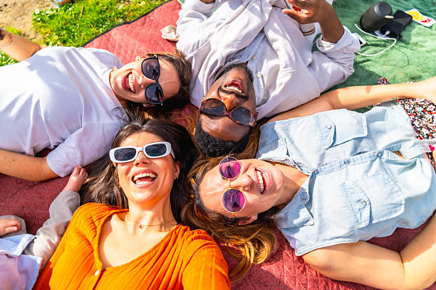 istock Happy friends lying in circle taking selfie at picnic 2204852652
