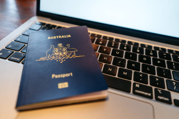 An Australian passport on a laptop indoors.