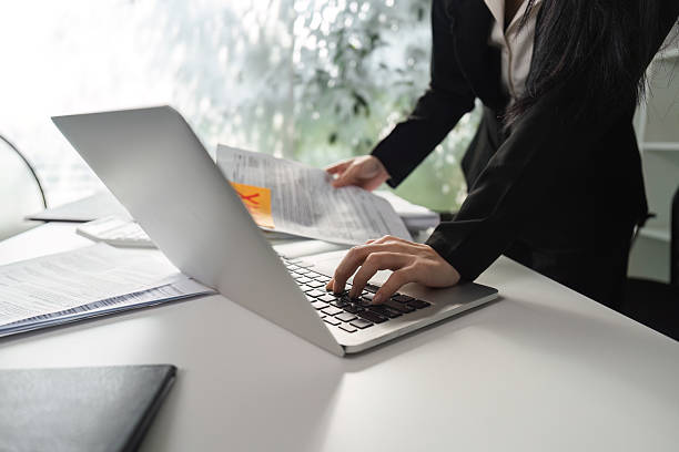 istock Business analysis. Professional accountant working on a laptop while reviewing financial documents in the office. 2204856438