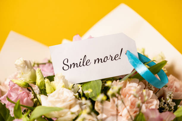 istock uplifting floral bouquet with heartfelt smile more message on elegant gift tag, accented by a delicate blue ribbon, set against a vibrant yellow background for a cheerful and inspiring touch 2204858975