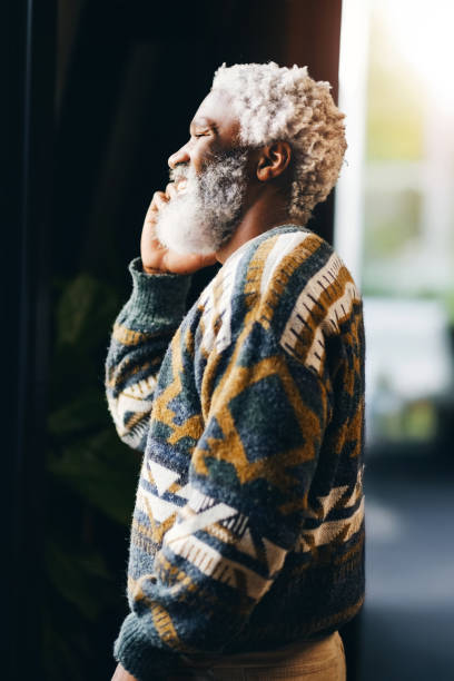 istock Smile, thinking and senior black man in home for nostalgia, idea and remember past memory. Happy person, retirement and vision in living room on weekend for reflection, inspiration and daydream 2204862278