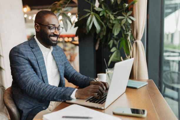istock Man Working on Laptop in Relaxing Cafe 2204862683