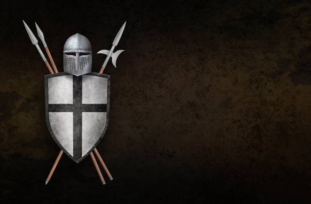 A knight in full armor stands in front of a brick wall. The knight is holding a sword and a shield. The scene is set in a room with a couch and a painting on the wall