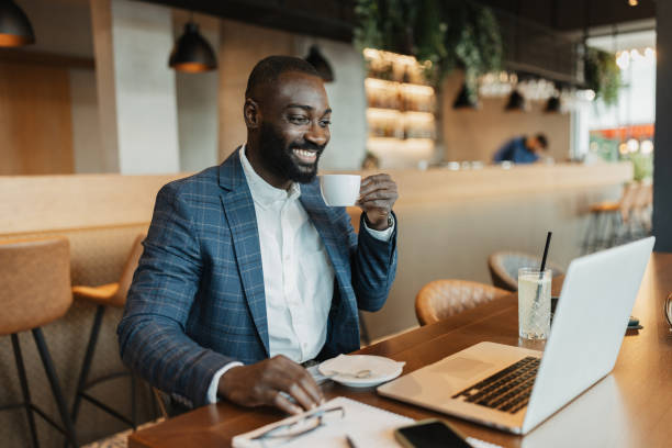 istock Businessman Smiling with Coffee in Hand 2204863300