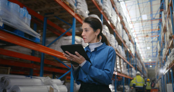 istock Logistics, woman and walk in warehouse with tablet, coordination and distribution. Quality control, manager and digital checklist in storage facility with delivery, export or shipping in supply chain 2204864041