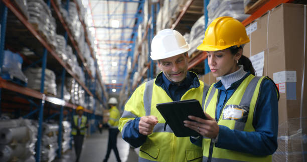 Quality control, woman and man in warehouse with tablet, coordination and distribution. Logistics, manager and digital checklist in storage facility with delivery, export or shipping in supply chain