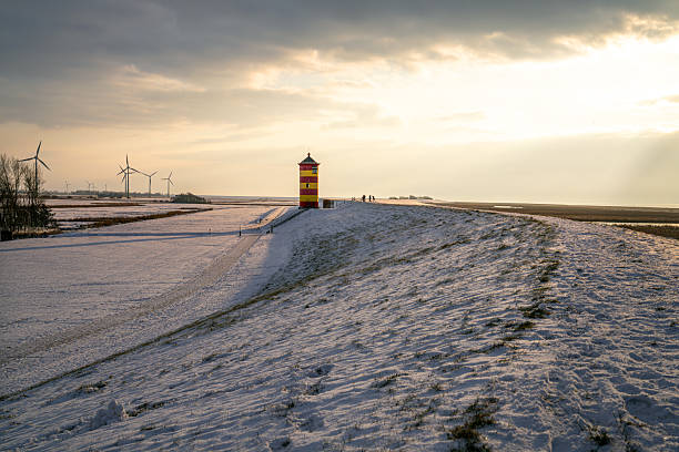 Pilsum, Germany - February 13, 2025: Lighthouse of Pilsum during sunset on February 13, 2025 in East Frisia, Germany