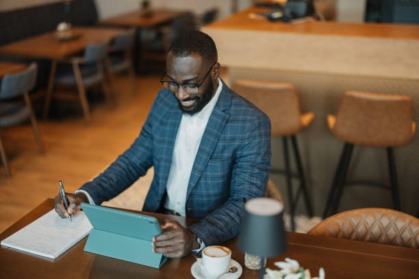 istock Businessman engaged in work at a cafe table 2204864336
