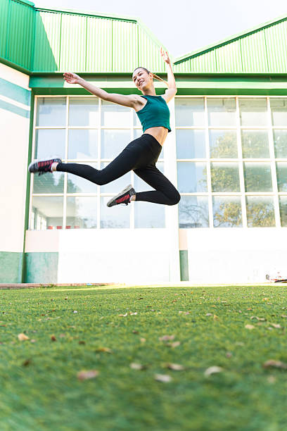 istock Rhythmic gymnast performing a jump outdoors 2204864842