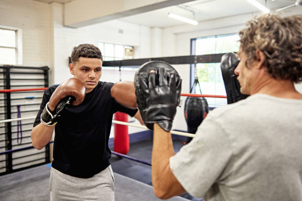 istock Teenage boxer training with focus mitts 2204864908