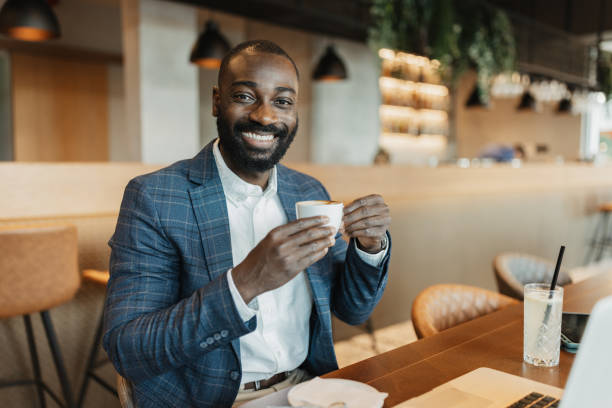 istock Happy Businessman Holding Coffee and Smiling 2204865100