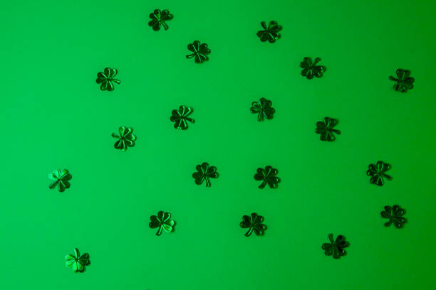 St. Patrick's Day background. Green shamrocks on a green background.