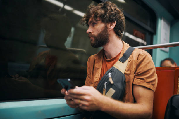 istock Phone, thinking and man on bus at night on vacation with online hotel checkin on mobile app. Cellphone, dark and male person reading tourism blog for tips, advice or rules for public transport travel 2204867230