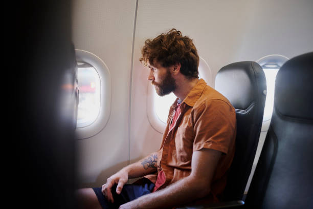 istock Man, plane window and thinking on travel with reflection, perspective and profile with career decision. Person, digital nomad and flight on airplane, insight and transport for international trip 2204867243