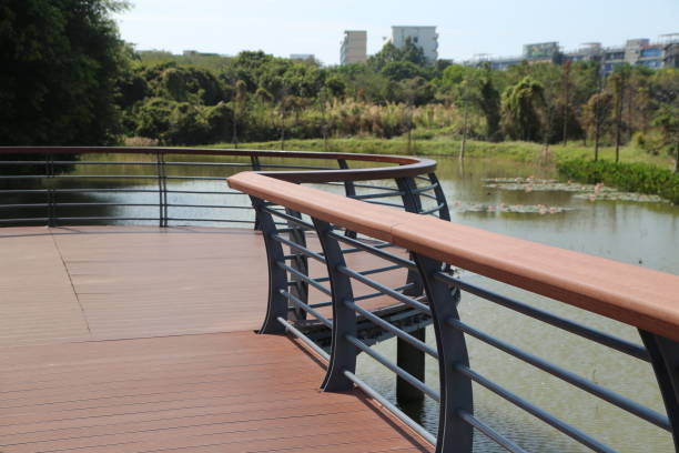 istock A wooden deck with a railing overlooking a body of water 2204867252