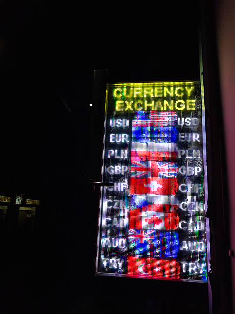 istock Illuminated currency exchange display board showcasing multiple international flags at nighttime 2204868531