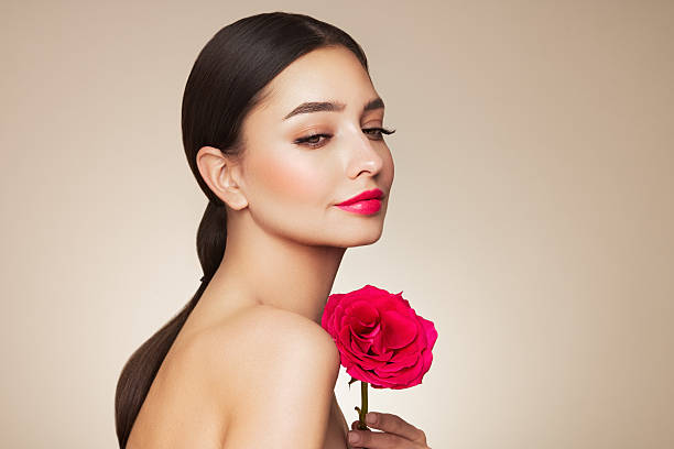 istock Beautiful young woman a rose flower 2204868742