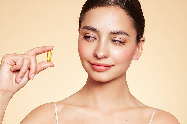 istock Beautiful Girl With Pill With Cod Liver Oil Omega-3 2204868756