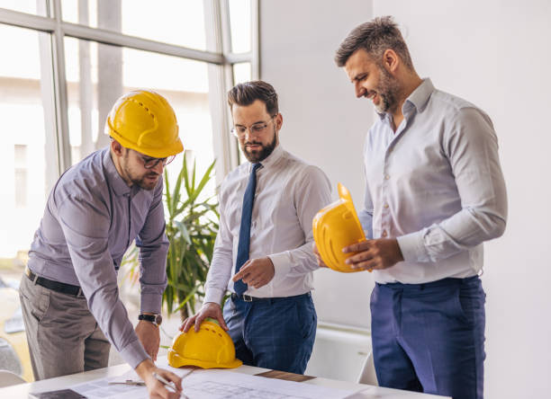 istock Architects reviewing blueprint in modern office 2204869960