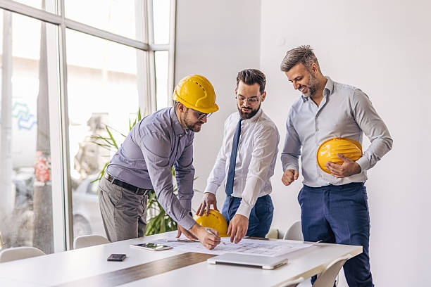 istock Architects reviewing blueprint in modern office 2204869961