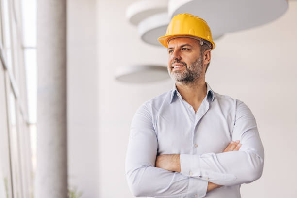 istock Confident architect smiling and looking away in modern office 2204870522