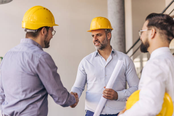 istock Engineers shaking hands after successful meeting in office building 2204872019