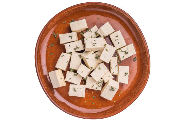 istock Uncooked Diced soybean tofu cheese on plate isolated on white background. top view 2204872805